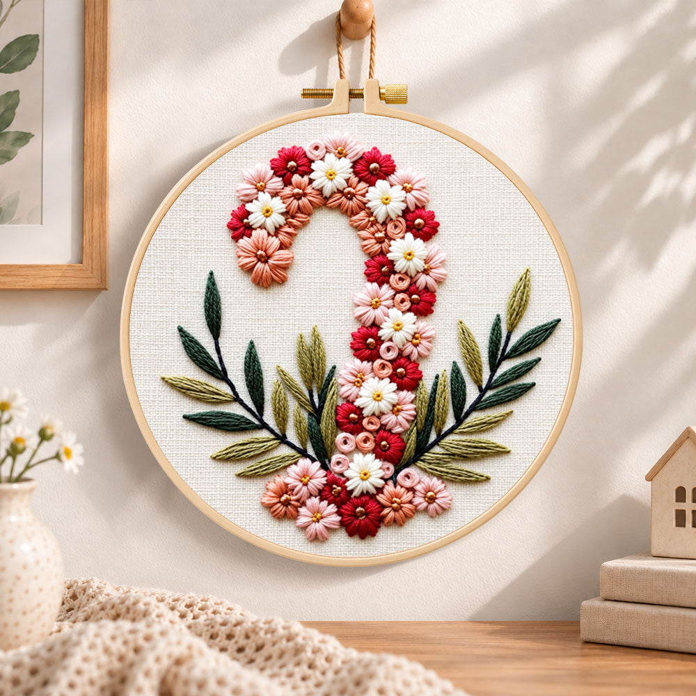 Floral candy cane design embroidery hoop wall art displayed as warm and cozy handmade home decor