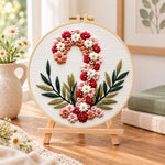Floral candy cane design embroidery kit finished hoop displayed on a wooden stand as cozy tabletop decor