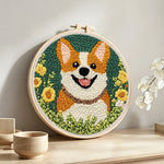 Floral corgi punch needle artwork displayed on a table