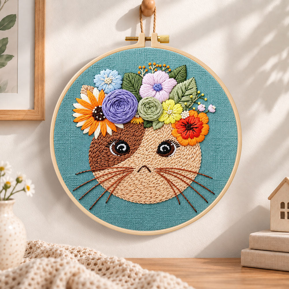 Floral crown kitty embroidery hoop wall art displayed as warm and cozy handmade home decor