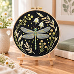 Floral dragonfly embroidery kit finished hoop displayed on a wooden stand as cozy tabletop decor