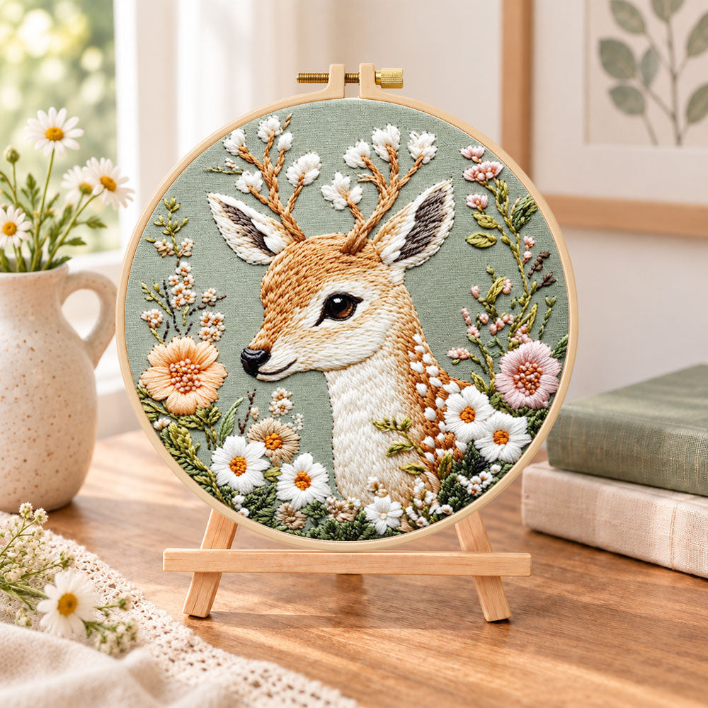 Floral fallow deer embroidery kit finished hoop displayed on a wooden stand as cozy tabletop decor