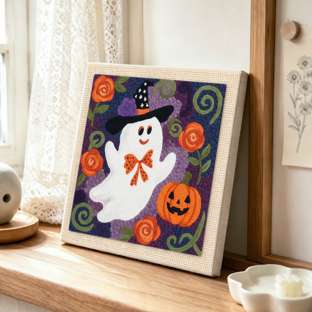 Floral ghost with witch hat punch needle artwork displayed on a table