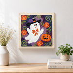 Finished floral ghost with witch hat artwork displayed on a wall