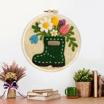 Finished floral green wellies boot vase artwork displayed on a wall