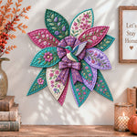 Floral hummingbird quilted bow displayed as handmade wall decor in a cozy home