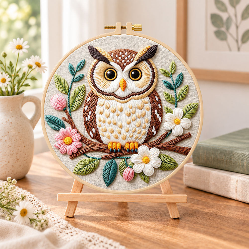 Floral owl on branch embroidery kit finished hoop displayed on a wooden stand as cozy tabletop decor