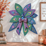Floral peacock quilted bow displayed as handmade wall decor in a cozy home
