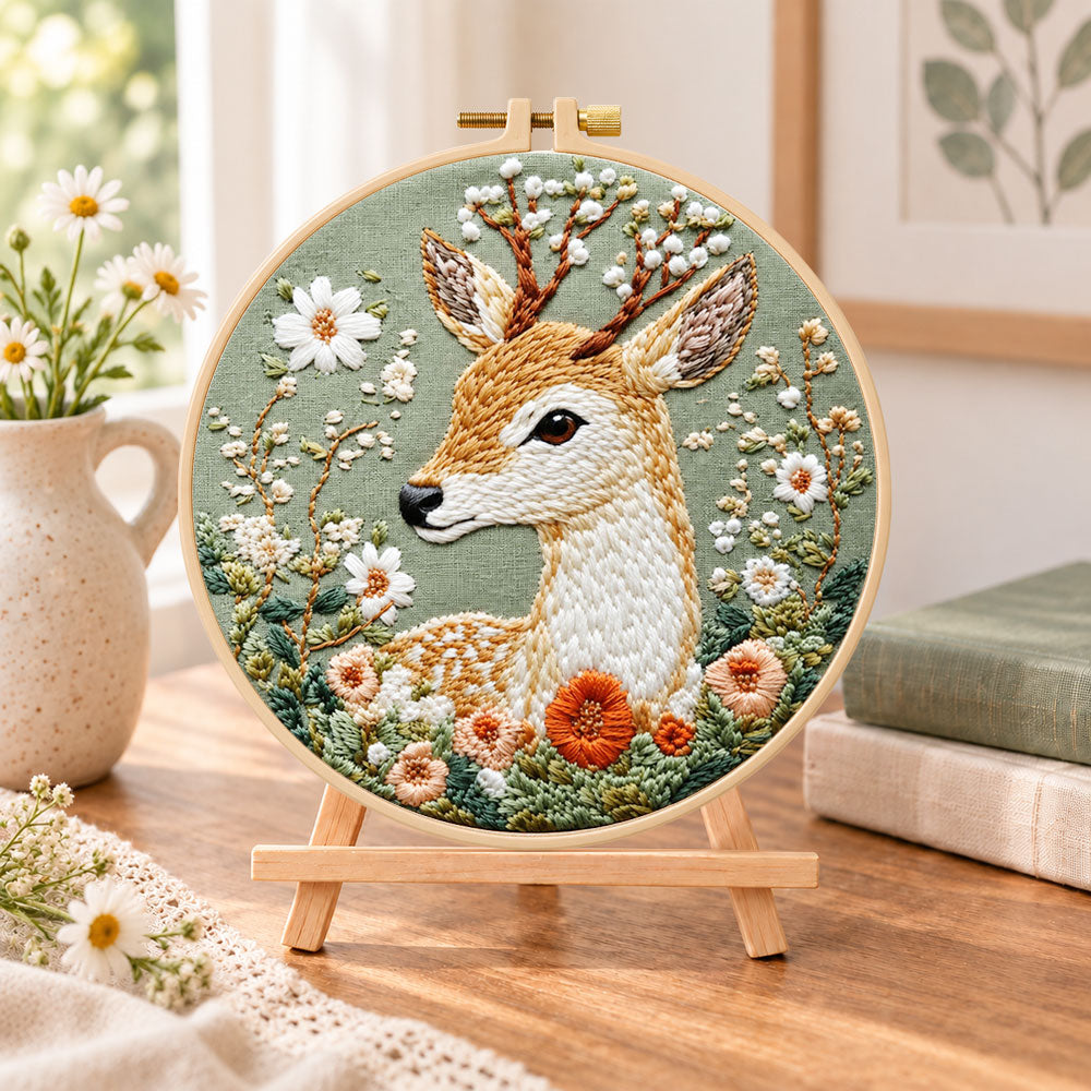Floral sika deer embroidery kit finished hoop displayed on a wooden stand as cozy tabletop decor