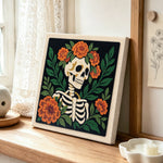 Floral skeleton side view punch needle artwork displayed on a table