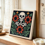 Floral skeleton with sunflowers punch needle artwork displayed on a table