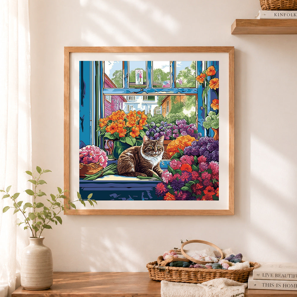 Finished flower windowsill tabby cat cross stitch artwork displayed as home decor