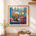 Finished flower windowsill tabby cat cross stitch artwork displayed as home decor