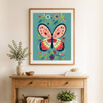 Finished folk style butterfly cross stitch artwork displayed as home decor