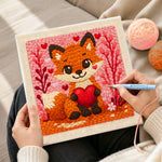 Creating handmade fox holding a red heart punch needle artwork