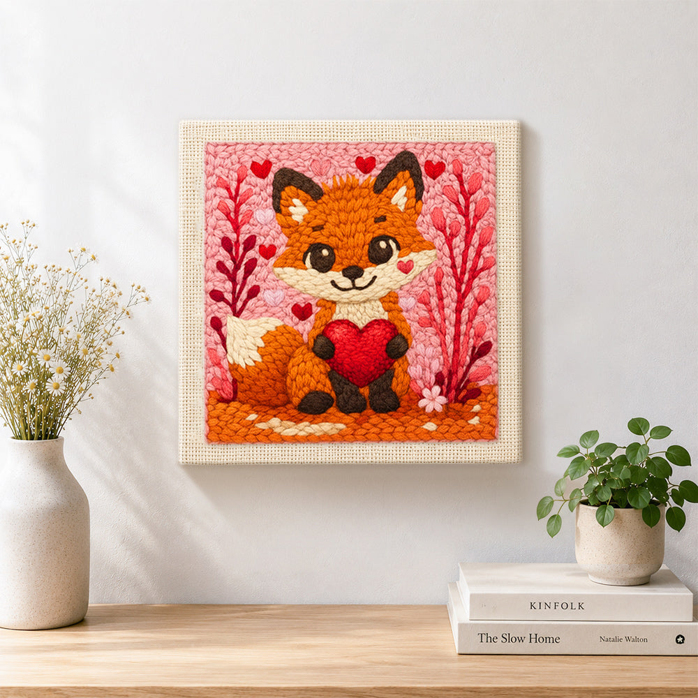 Finished fox holding a red heart artwork displayed on a wall