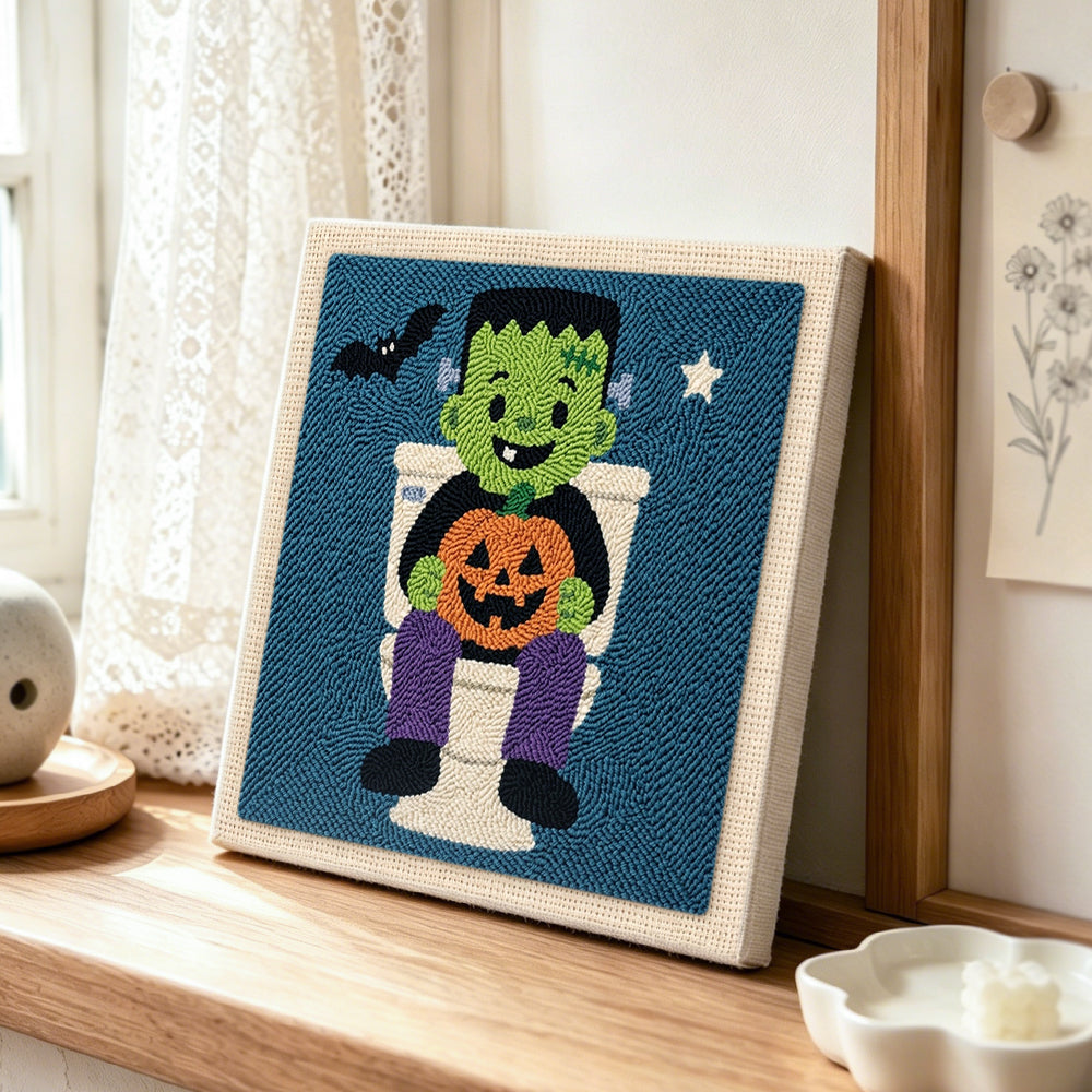 Frankenstein on toilet punch needle artwork displayed on a table