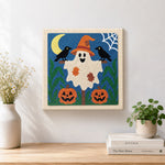 Finished friendly ghost with witch hat artwork displayed on a wall