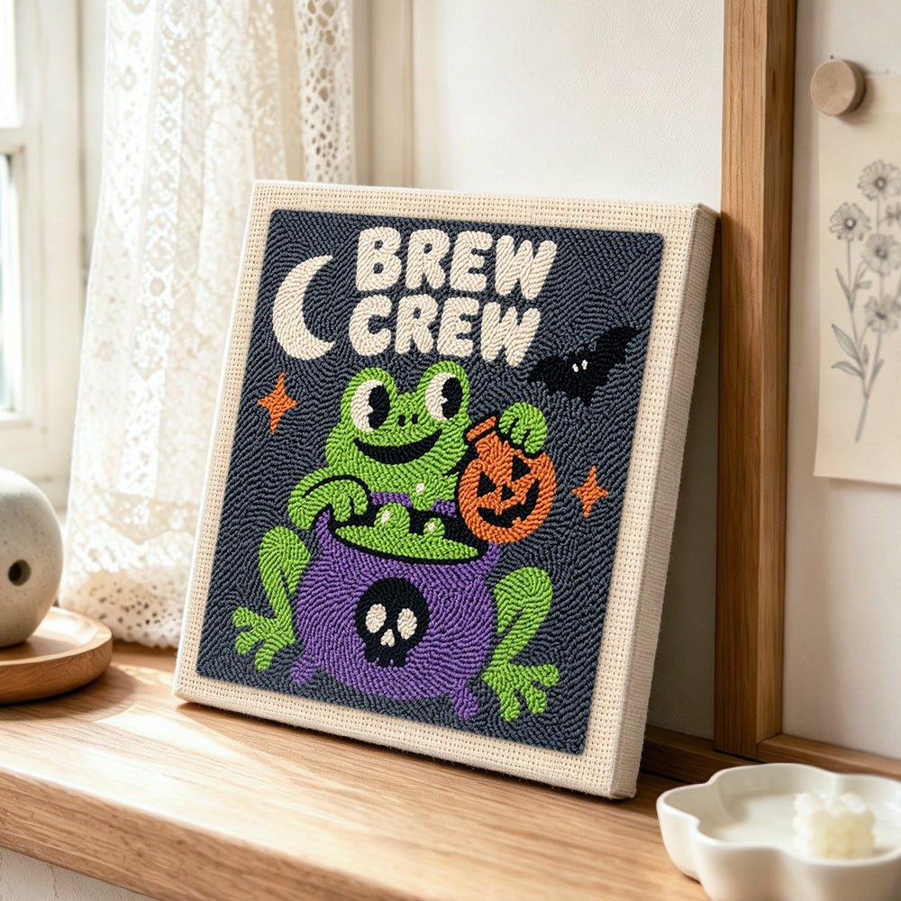 Frog brew crew punch needle artwork displayed on a table