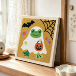 Frog ghost in disguise punch needle artwork displayed on a table