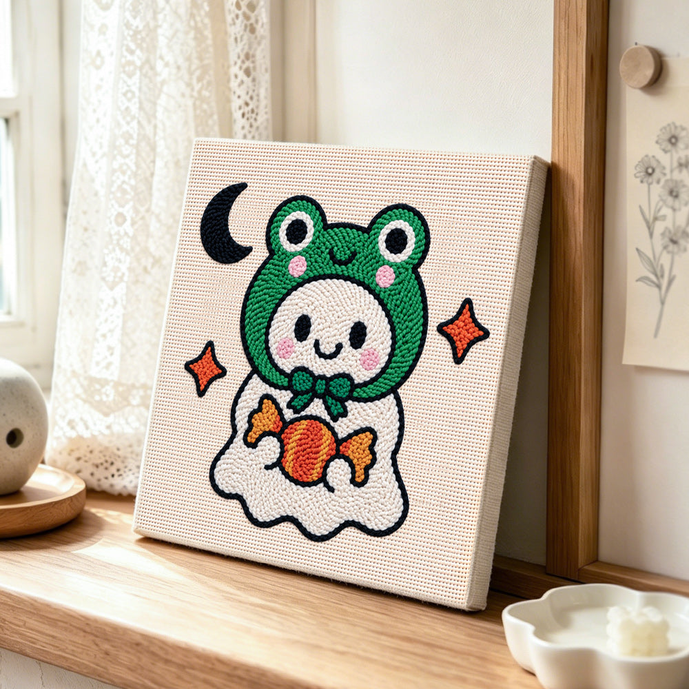 Frog ghost with candy punch needle artwork displayed on a table