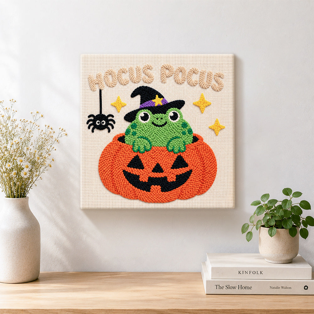 Finished frog witch inside pumpkin artwork displayed on a wall