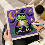 Creating handmade frog wizard standing on cat punch needle artwork