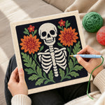 Creating handmade front‑facing floral skeleton punch needle artwork