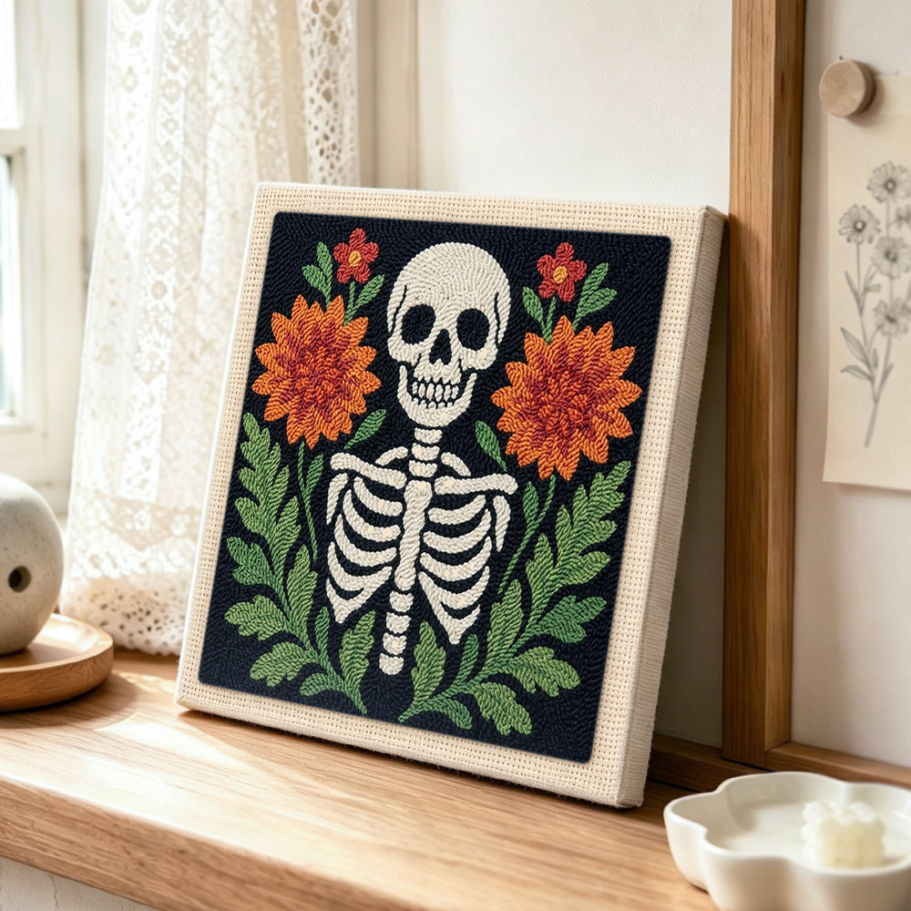 Front‑facing floral skeleton punch needle artwork displayed on a table