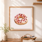 Finished frosted donut cross stitch artwork displayed as home decor