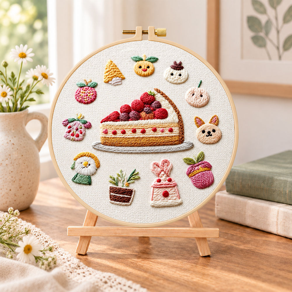 Fruit pie and whimsical motifs embroidery kit finished hoop displayed on a wooden stand as cozy tabletop decor