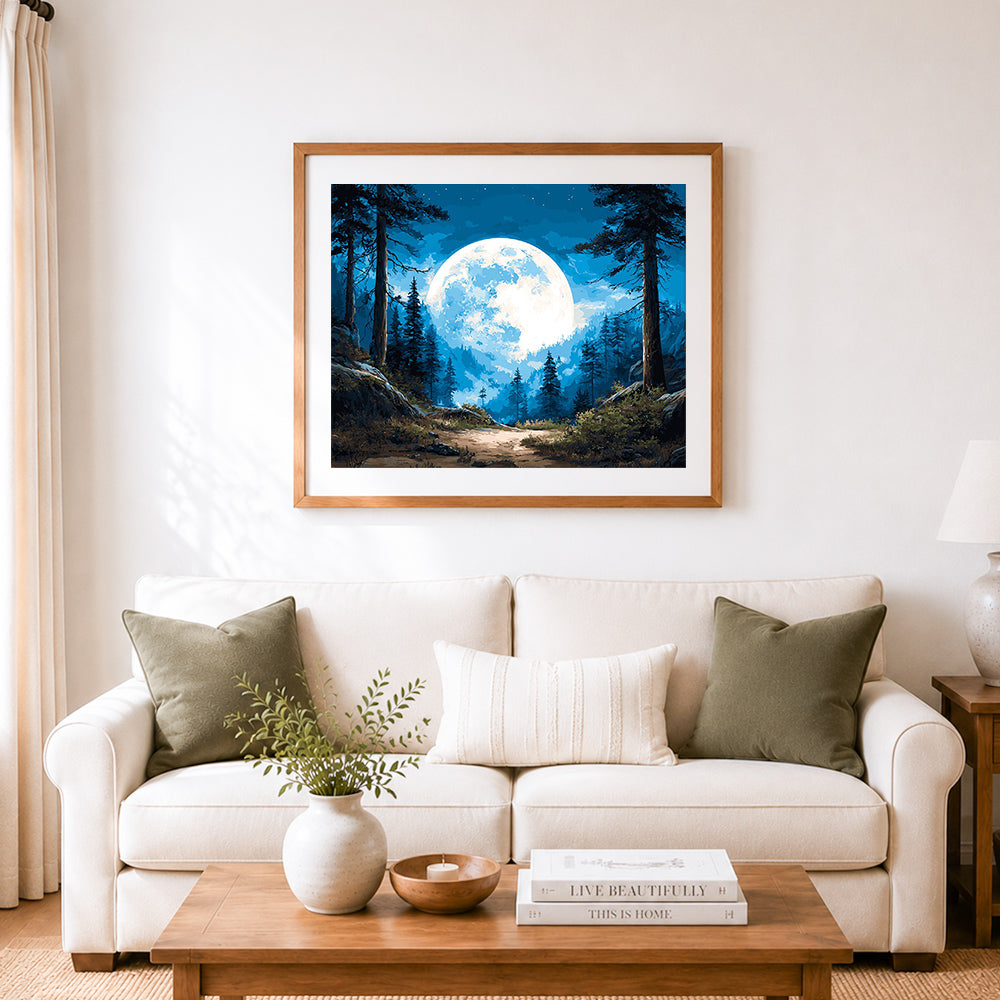 Finished full moon over pine woods cross stitch artwork displayed as home decor