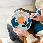 Creating handmade geometric orange tulip punch needle artwork