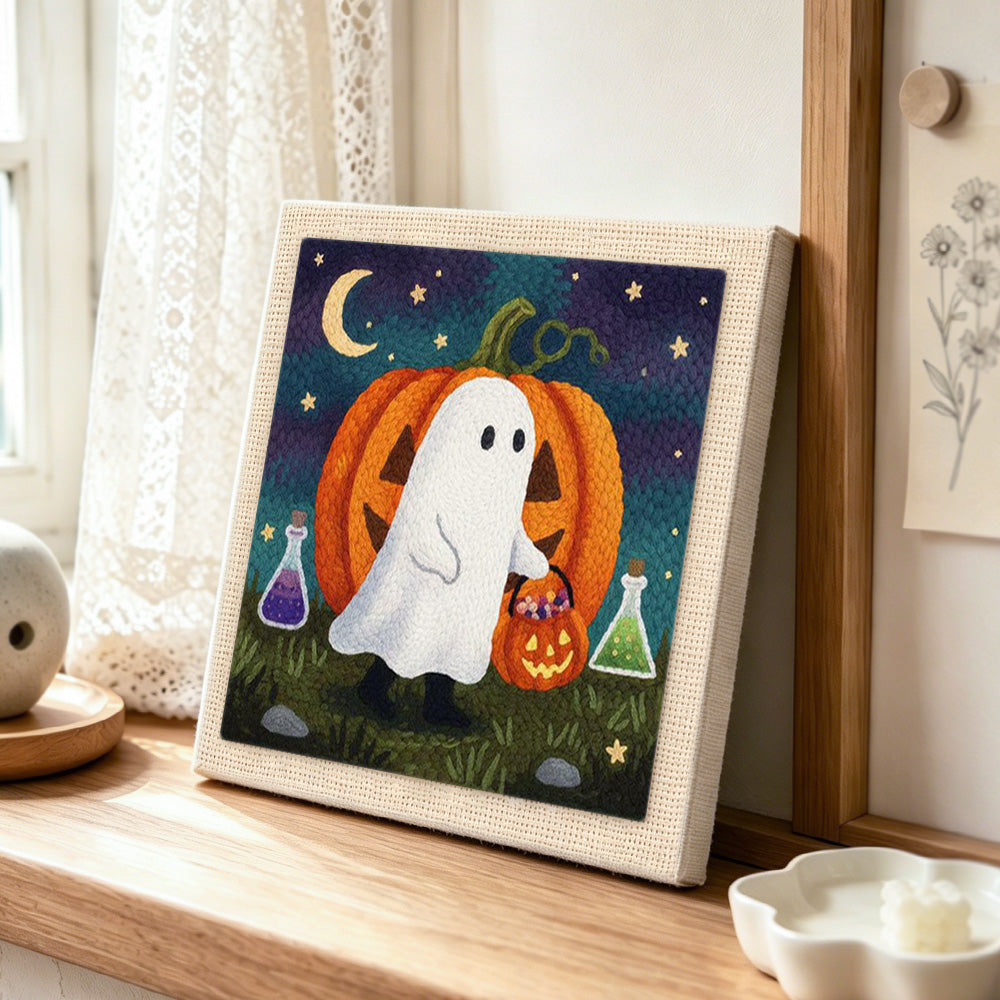 Ghost and pumpkin trick or treat punch needle artwork displayed on a table