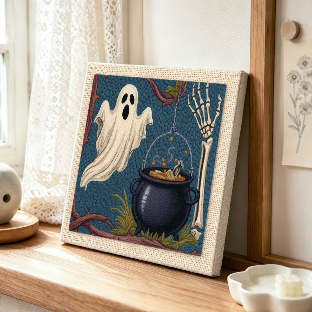 Ghost and witch cauldron punch needle artwork displayed on a table