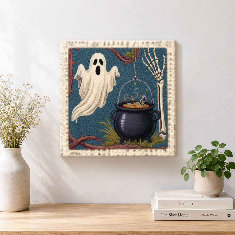 Finished ghost and witch cauldron artwork displayed on a wall