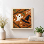 Finished ghost and witch hat artwork displayed on a wall