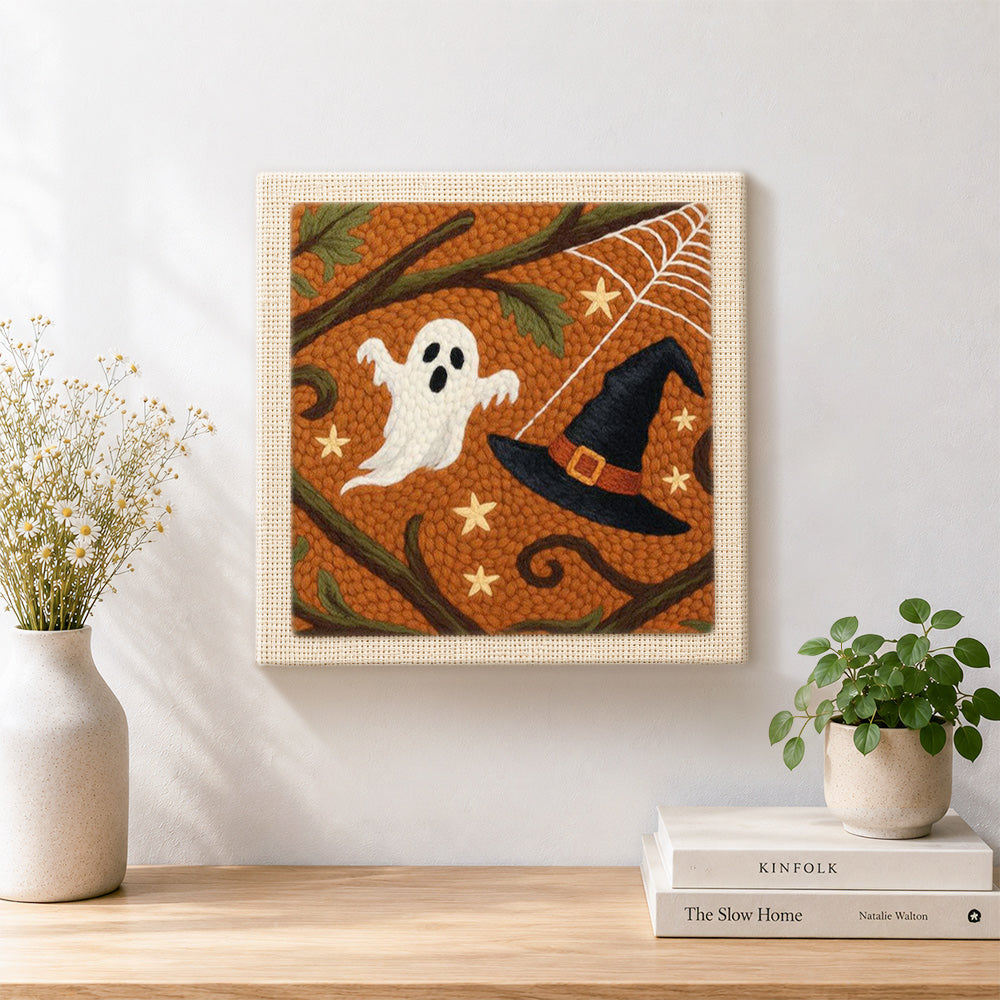 Finished ghost and witch hat artwork displayed on a wall