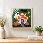 Finished ghost at mushroom house artwork displayed on a wall