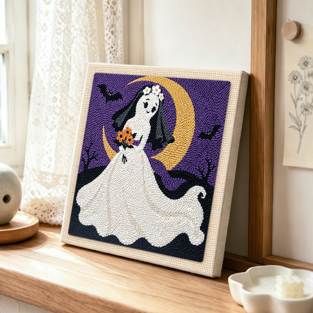 Ghost bride with moon punch needle artwork displayed on a table