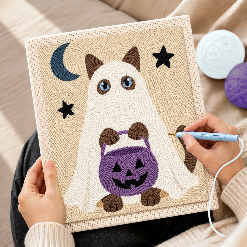 Creating handmade ghost cat holding pumpkin treat bucket punch needle artwork