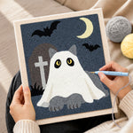 Creating handmade ghost cat in graveyard punch needle artwork