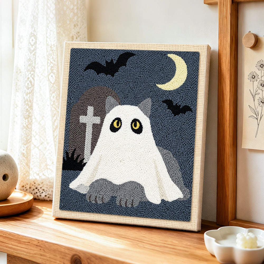 Ghost cat in graveyard punch needle artwork displayed on a table
