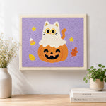 Finished ghost cat on pumpkin artwork displayed on a wall