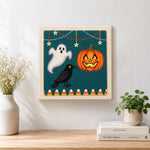 Finished ghost crow and pumpkin harvest artwork displayed on a wall