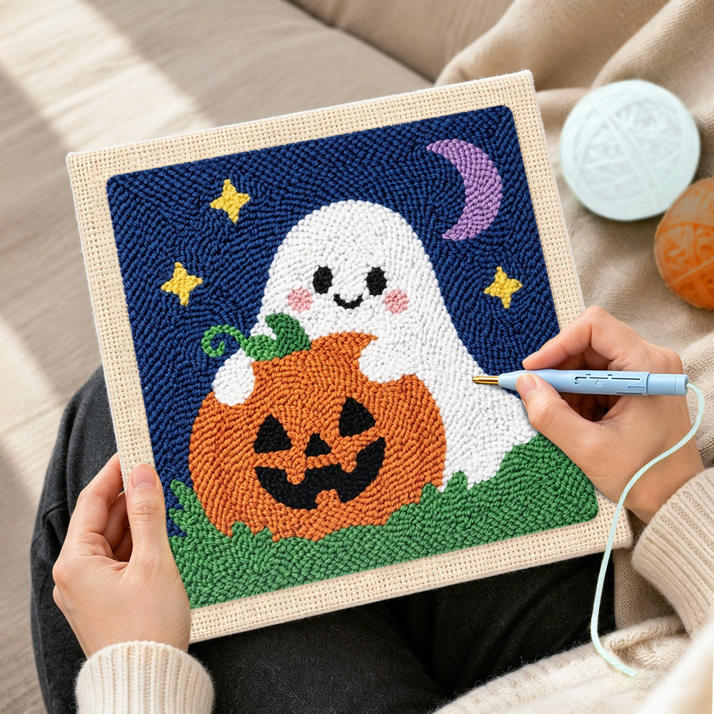 Creating handmade ghost hugging pumpkin punch needle artwork