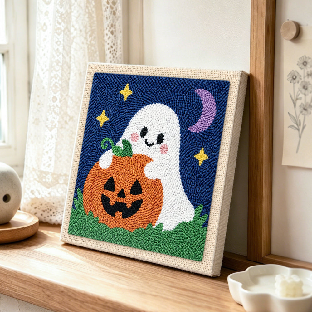 Ghost hugging pumpkin punch needle artwork displayed on a table
