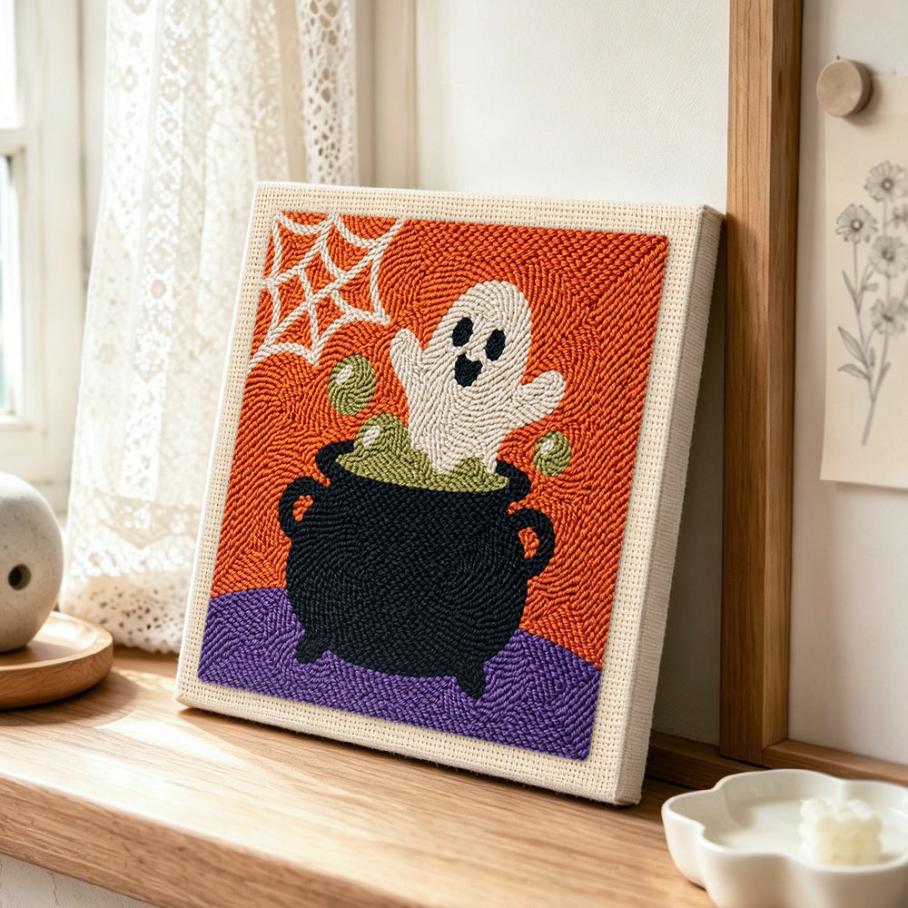 Ghost in cauldron punch needle artwork displayed on a table