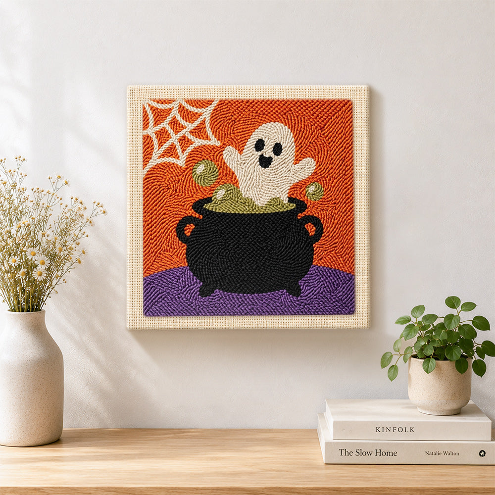 Finished ghost in cauldron artwork displayed on a wall