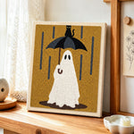Ghost in rain punch needle artwork displayed on a table